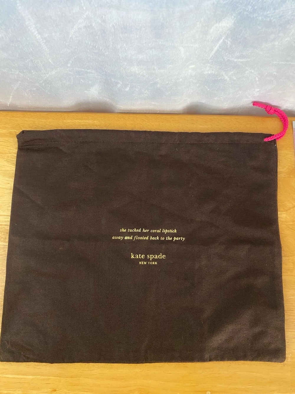 kate spade brown dust bag with pink drawcord and gold logo